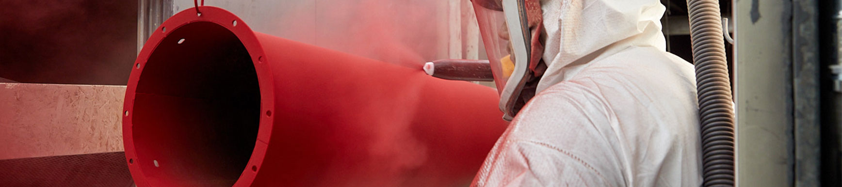 Large Red Metal Tube Being Powder Coated with Paint Gun Jensen Powder Finishers in Southeastern Wisconsin Powder Coating Wisconsin